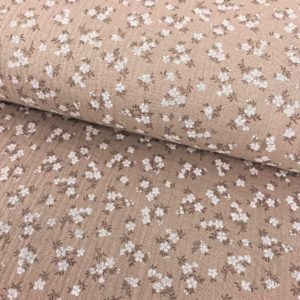 Tela de muselina o tela de doble gasa, algodón 100x100. Tejido con estampado de florecitas blancas fondo marrón beige