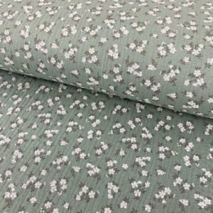 Tela de muselina o tela de doble gasa, algodón 100x100. Tejido con estampado de florecitas blancas fondo verde mint