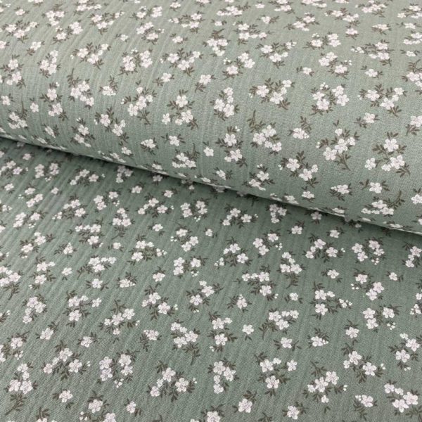 Tela de muselina o tela de doble gasa, algodón 100x100. Tejido con estampado de florecitas blancas fondo verde mint