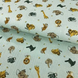 Tela de muselina o tela de doble gasa, algodón 100x100. Tejido con estampado de animales de la jungla fondo mint.