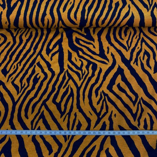 Tela de punto de viscosa elástica estampada animal print zebra en color ocre y azul marino.