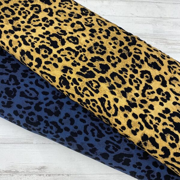 Tela de vestir de viscosa 100% estampado animal print de pantera con manchas en negro y fondo azul índigo o mostaza.