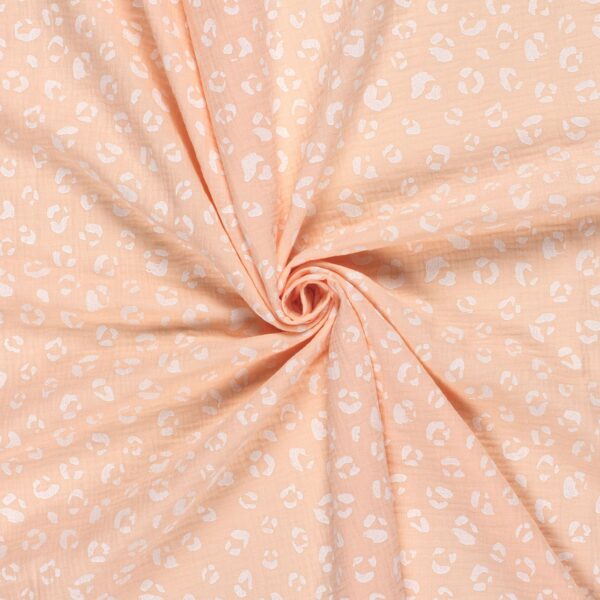 Tela de muselina o tela de doble gasa, algodón 100x100. Tejido con estampado de manchas tipo animal print en blanco fondo salmón rosado