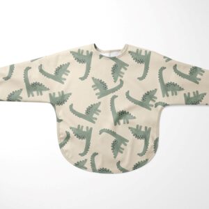 Plástico Aqua Protect estampación digital con dinosaurios verdes fondo crudo. Tejido impermeable, flexible, ligero y de tacto suave. Ideal para confecciones para los más pequeños de la casa.