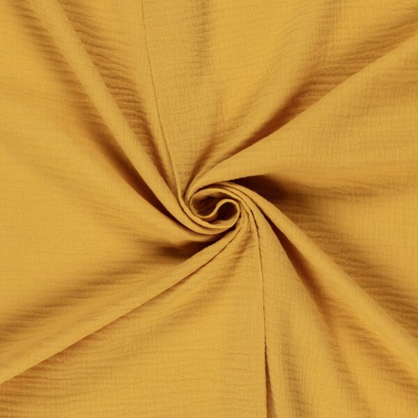 Tela de muselina o doble gasa de algodón ocre. Tejido de algodón muy suave y ligero. Textura rugosa y transiprable. Ideal para confecciones del hogar o infantiles.