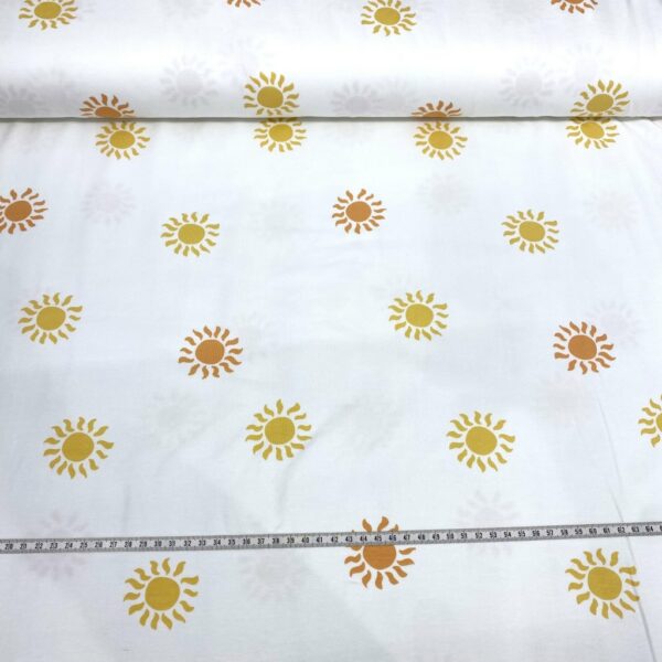 Tela de punto de camiseta de algodón orgánico. Tipo Jersey estampado con soles amarillos y naranjas fondo blanco roto
