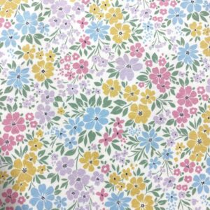 Tela de punto de camiseta de algodón orgánico. Tipo Jersey estampado con flores de colores fondo blanco roto.