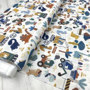 Algodón infantil con dinosaurios y herramientas, ideal para proyectos creativos y ropa infantil.