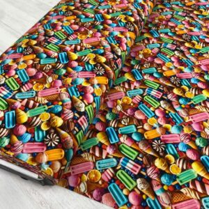 Imagen de un pastel decorado con pequeños lapiceros de colores y dulces.