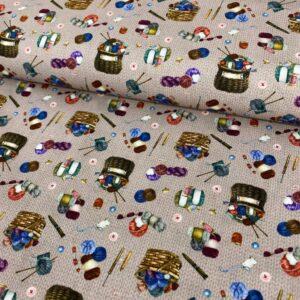 Alto nivel de detalle en tela de algodón con ovillos y agujas de tejer, ideal para proyectos de cost.