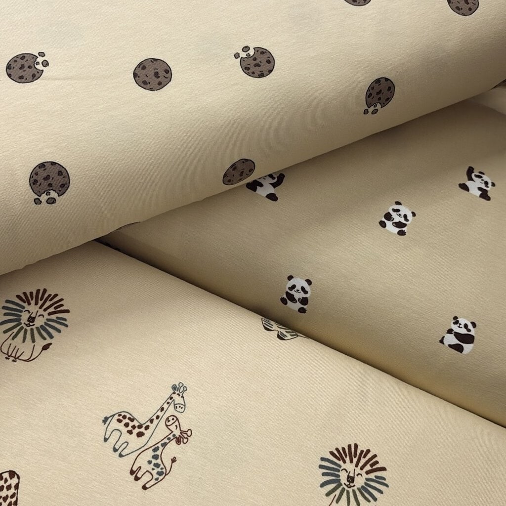 Estampado de pandas, jirafas y manchas en telas de algodón para decoración infantil.
